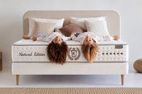 Two children relaxing on the NATUR premium mattress with natural cotton, wool and latex, available at PALMA BEDS in Mallorca.